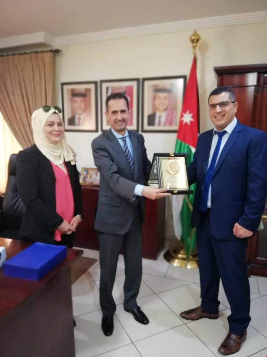 Presenting the shield of Al Istiklal Hospital to HE Ambassador Saqr Abu Shatal